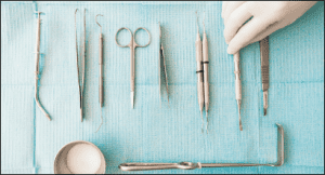 detail-of-hand-holding-dental-tools-in-dental-clin-86BFARE